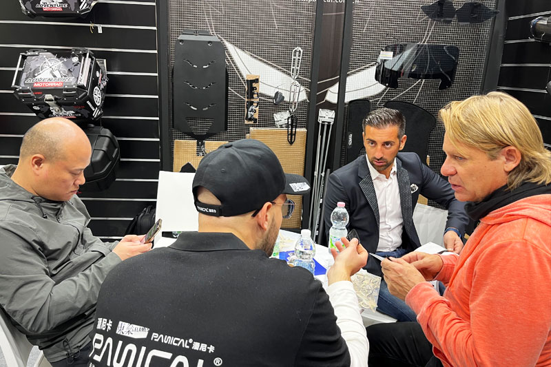 Business discussion at the PANICAL booth during the 2023 Milan Motorcycle Show