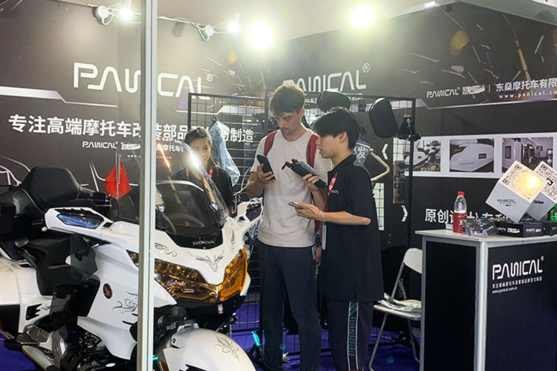 Visitors viewing a touring motorcycle at the PANICAL booth during the 2024 Chongqing Motorcycle Expo