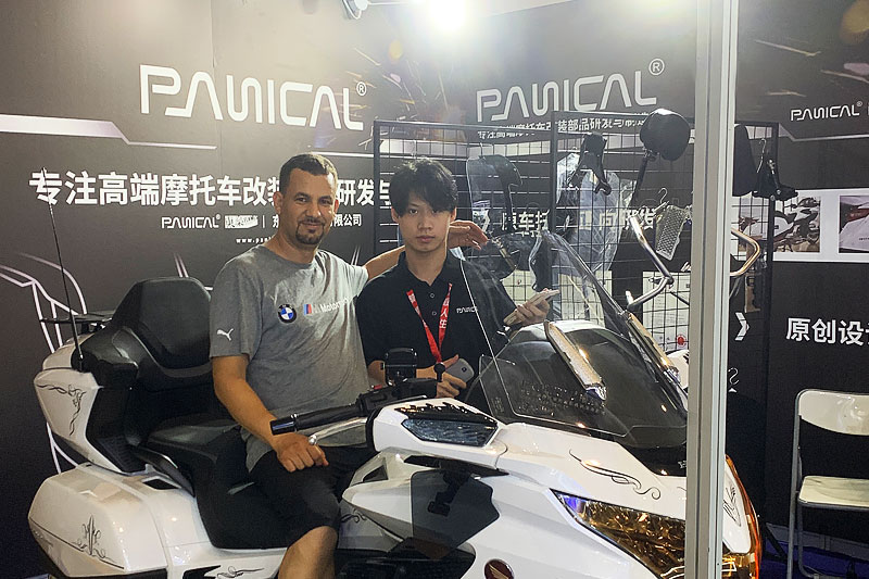 Touring motorcycle display and visitors at the PANICAL booth during the 2024 Chongqing Motorcycle Expo